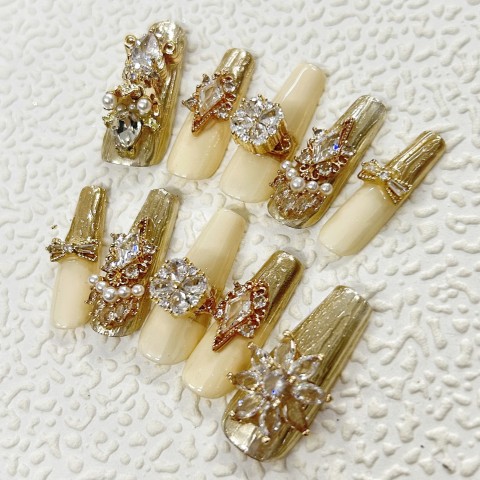 Luxury gold manicure, swirling Swarovski